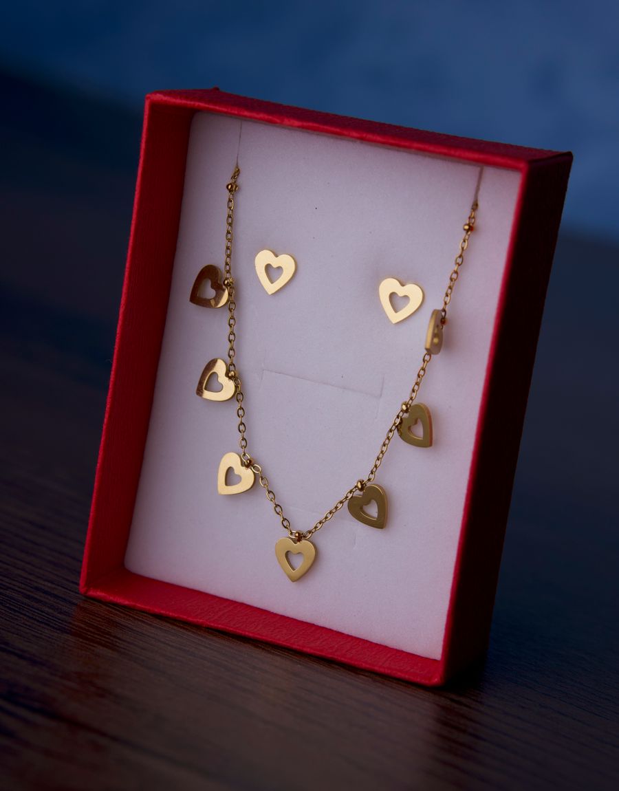 Gold heart necklace and earring set in a red box