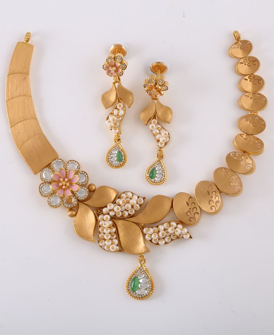 Gold necklace and earring set with intricate floral detailing